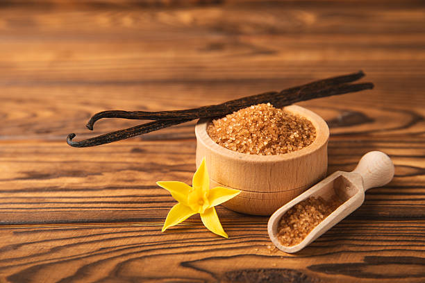 istock Aromatic vanilla sugar. Vanilla pods. Vanilla sticks, brown and white sugar in a bowl on a textured background. Vanilla flowers, spices and herbs for desserts and baking. Space for text. Copy space 2209623257