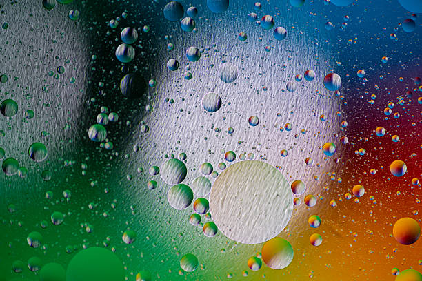 istock holiday light background. holiday postcard background. oil drops on the water surface 2209623312