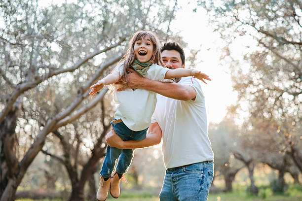 istock Carefree young father and daughter hugging in spring day. 2209623812