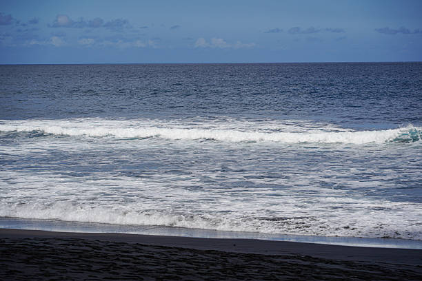 Volcanic sand beach, sea and blue sky in La Palma island in Canary islands, Atlantic Ocean, Spain