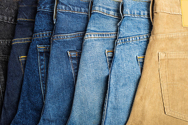 istock blue, light blue, black and brown jeans are laid out in a horizontal row. 2209625742