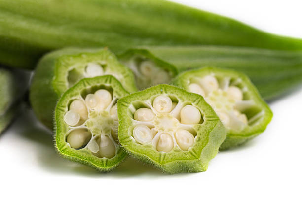 Green fresh okra. Pieces on a white background. macro photography.