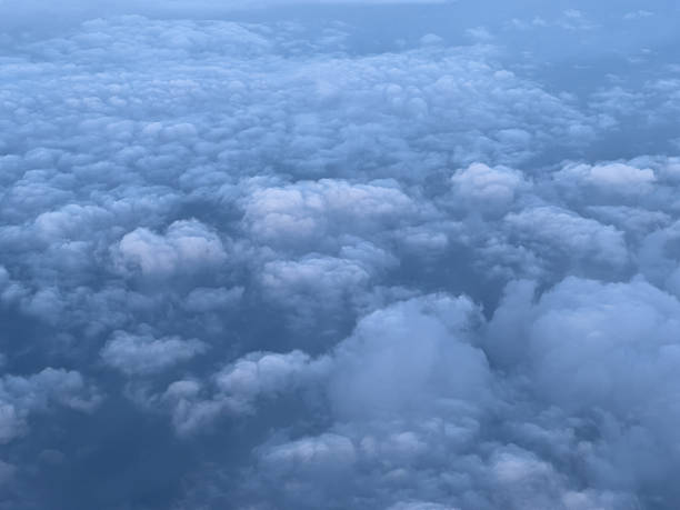 istock Porthole view of cumulus clouds on blue sky 2209629093