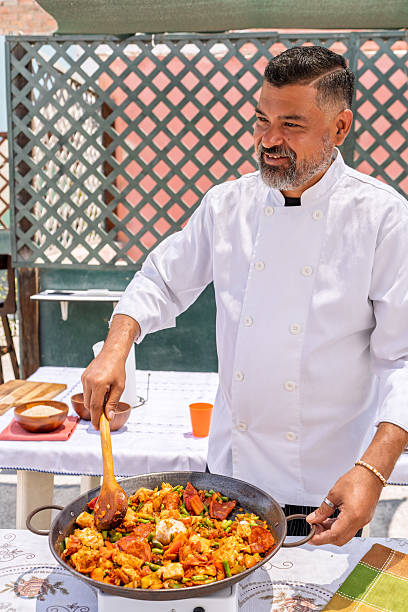 istock Chef cooking paella outdoors for family gathering 2209634955