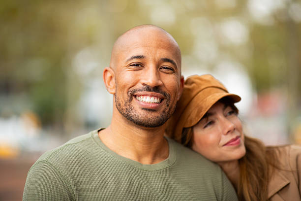 istock man smiles confidently while his partner leans in, resting her head on his shoulder. 2209636417