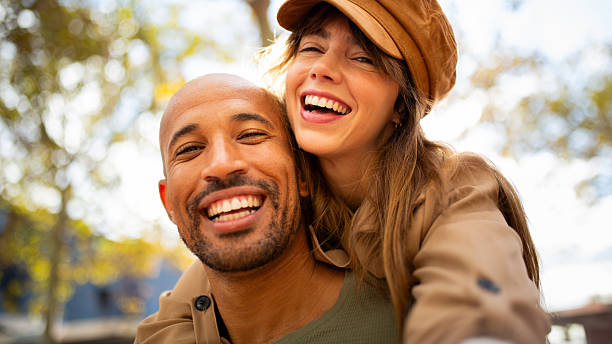 istock laughing couple creating memories by taking selfie outdoors 2209636421