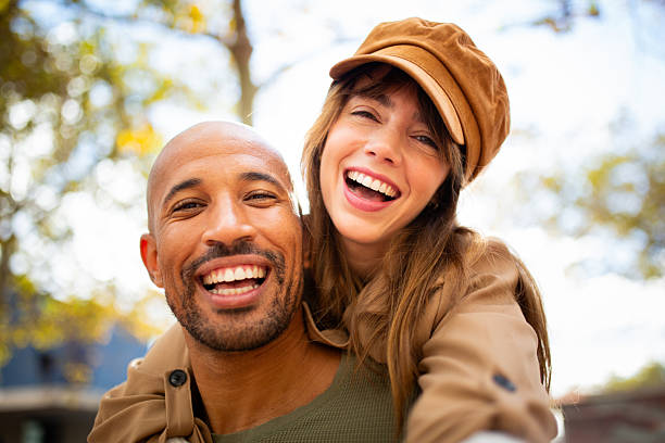 istock smiling, cheerful couple outdoors taking piggyback selfie 2209636511