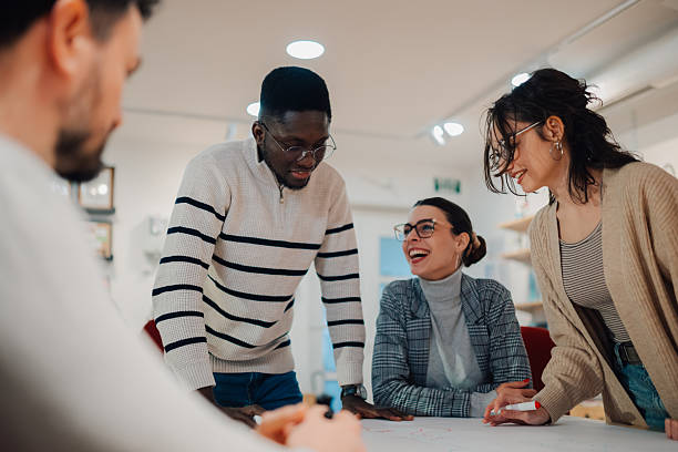 istock Group of young professionals collaborating on project in modern office 2209636618