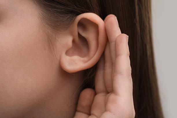 istock Little girl with hearing problem on grey background, closeup 2209638861