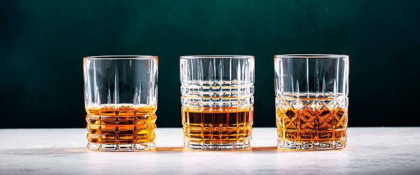 istock Blended Scotch whiskey glasses on dark green background 2209639208