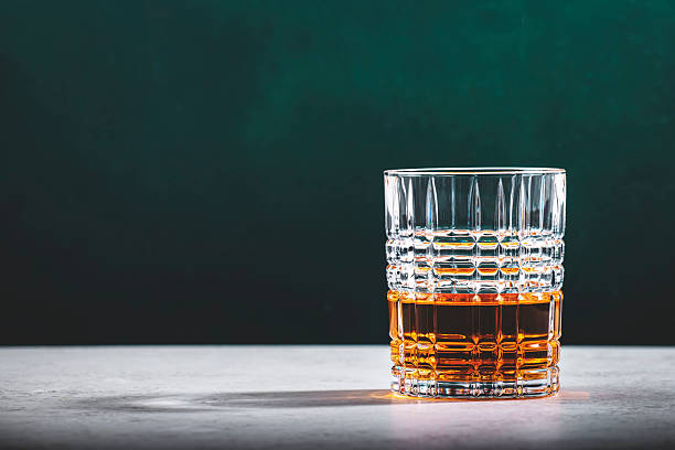 istock Pot still irish whiskey in glass on dark green background 2209639210