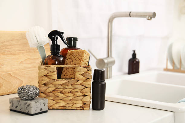 istock Different cleaning supplies in basket on countertop. Space for text 2209639546