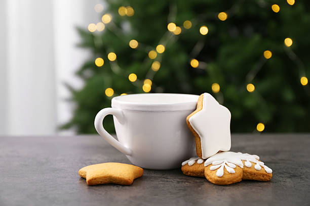 istock Decorated cookies and hot drink on grey table against blurred Christmas lights 2209639674