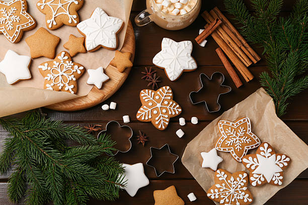 istock Decorated Christmas cookies and fir tree branches on wooden table, flat lay 2209639704