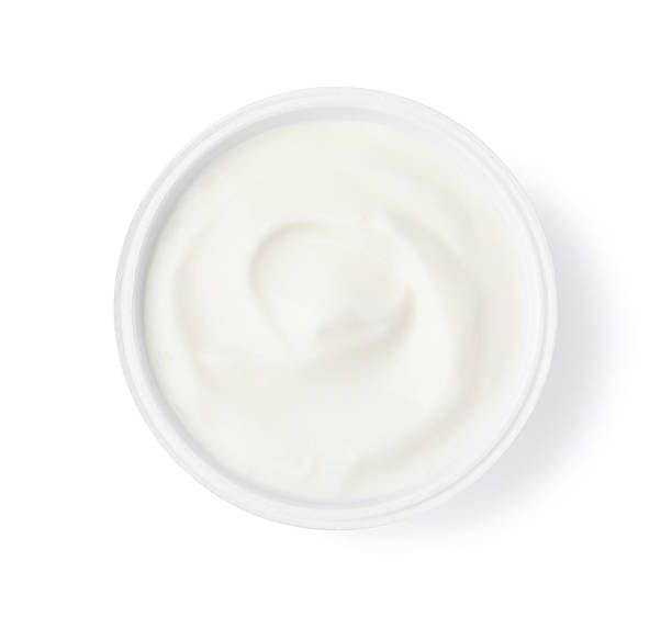 istock Delicious natural yogurt in plastic cup isolated on white, top view 2209639726