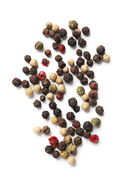 Aromatic spices. Pile of different peppers isolated on white, top view