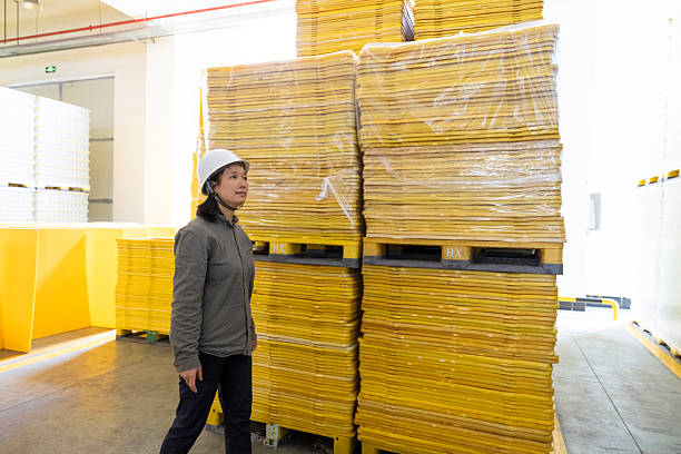 A female worker is taking inventory in the material warehouse