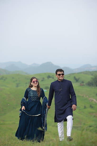 istock Couple spending leisure time together on lush mountain landscape 2209661254