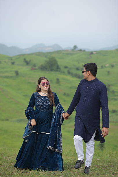 istock Couple spending leisure time together on lush mountain landscape 2209661276
