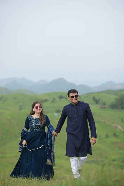 istock Couple spending leisure time together on lush mountain landscape 2209661285
