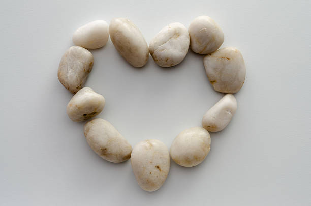 Top view of single gray pebble isolated on white background.
