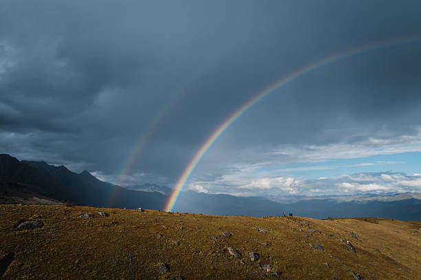 Beautiful double rainbow after the rain on high altitude mountain top