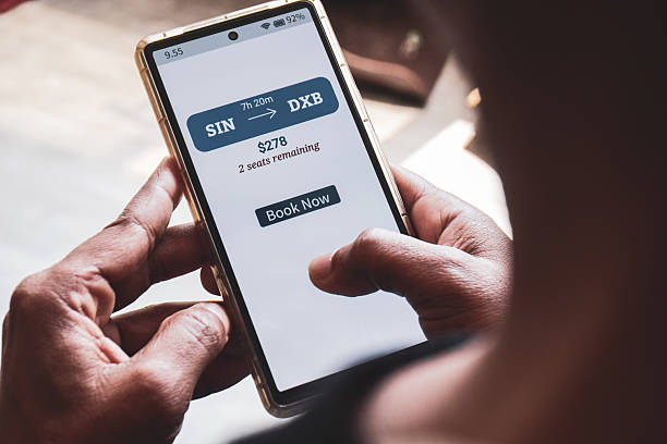istock Man using mobile applications to book flight online showing one way ticket price with remaining seats available. Example of FOMO Marketing, urgency or anxiety to purchase immediately. 2209672836