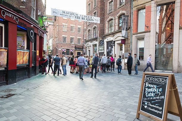 LIVERPOOL, UNITED KINGDOM - JUNE 7, 2014: Saturday afternoon in Liverpool, people have fun in bars Mathew Street famous for being the home of The Cavern Club - one of the venues in which 'The Beatles' began their career