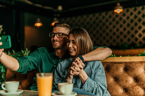 istock Young couple taking a selfie while having breakfast at the coffee shop 2209673859