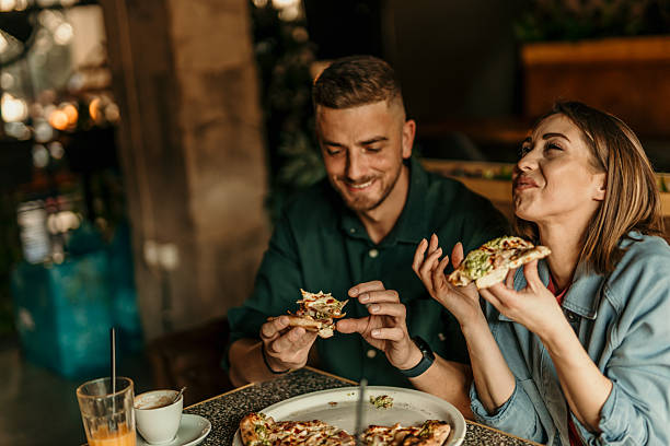 Young couple enjoying pizza at a restaurant