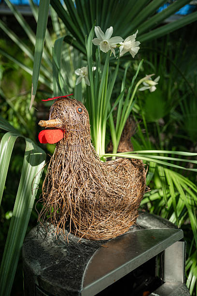 istock Handmade decorative chicken figure and pastel eggs in garden setting. Spring and Easter symbol 2209674859