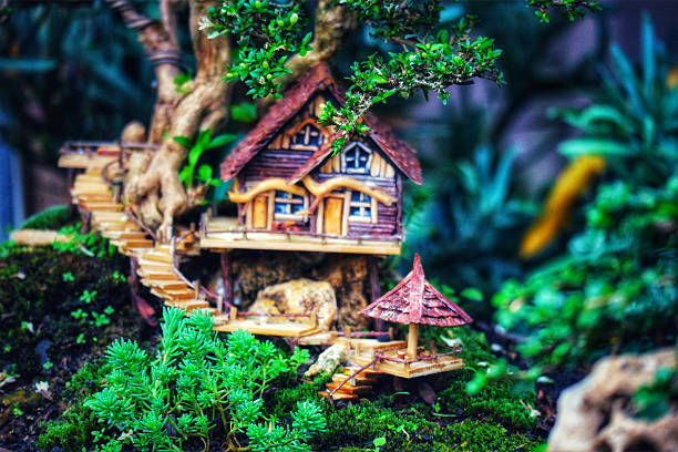 A charming miniature treehouse nestled in a lush bonsai garden.  Wooden walkways wind through vibrant green moss, creating a tranquil, fairytale-like atmosphere.