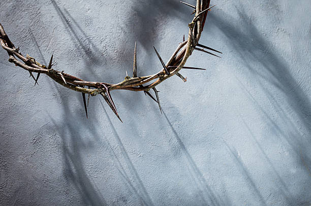 Crown of thorns projecting shadowy silhouette against textured gray surface, symbolizing spiritual pain and redemptive struggle good friday for Christian background, Easter concept