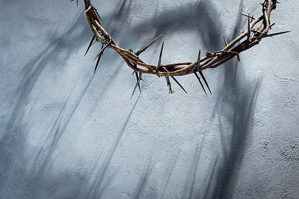 istock Jesus Crown of thorns projecting shadowy silhouette against textured gray surface, symbolizing spiritual pain and redemptive struggle Banner good friday for Christian background, Easter concept 2209679011