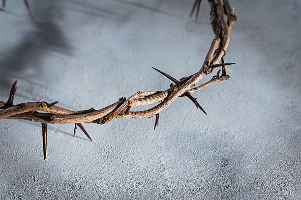 istock Jesus Crown of thorns projecting shadowy silhouette against textured gray surface, symbolizing spiritual pain and redemptive struggle good friday for Christian background, Easter concept 2209679051