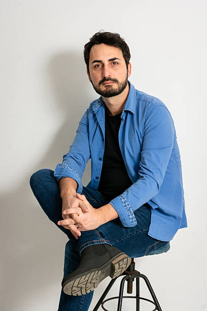 istock Mid adult man sitting against white background 2209684274