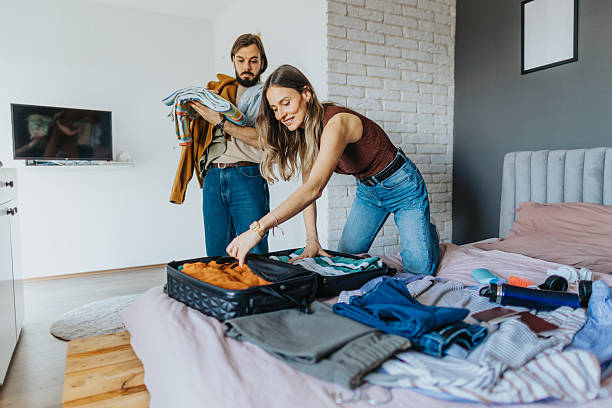 istock Happy young couple packing for a trip 2209684773