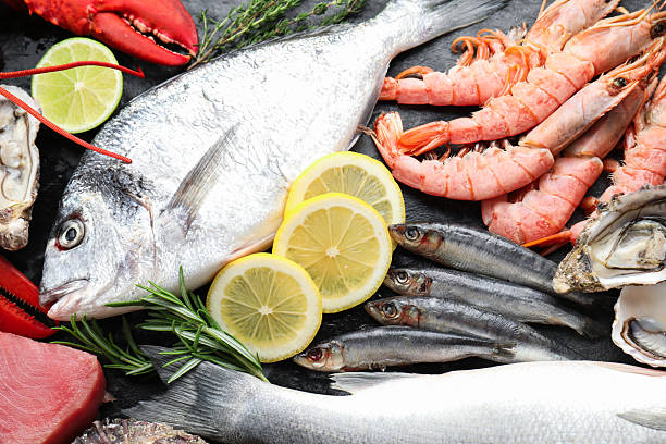 istock Fresh fish and different sea food on table, top view 2209684803