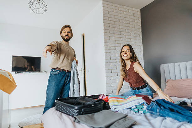 istock Happy young couple packing for a trip 2209684821