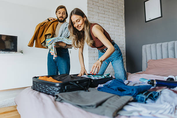 istock Happy young couple packing for a trip 2209685026