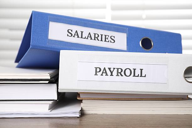 istock Office folders with words Payroll and Salaries on wooden table, closeup 2209685030