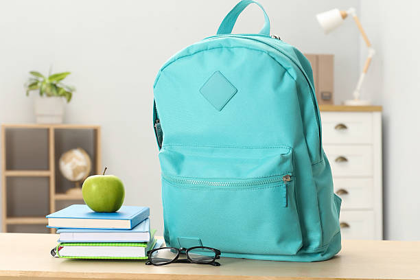 istock Backpack and different school stationery on wooden table indoors 2209685146