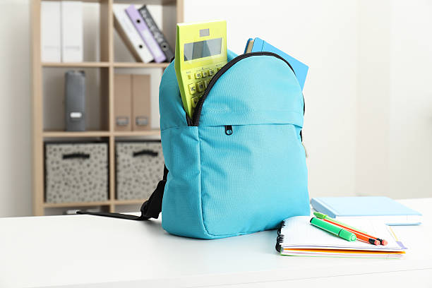 istock Backpack and different school stationery on white table indoors 2209685198