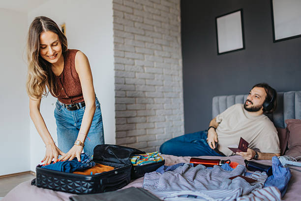 istock Cheerful young couple at home preparing for vacation 2209685238