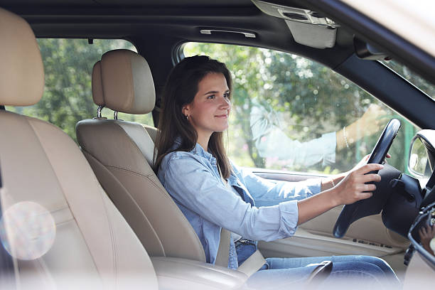 istock Woman holding steering wheel while driving car 2209685413