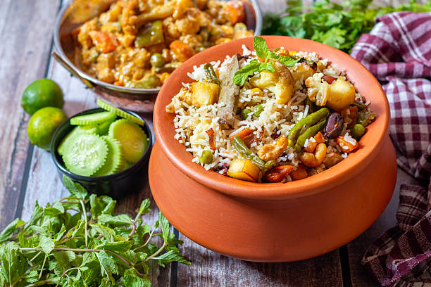 istock Navratan Pulao is a rich, aromatic Indian rice dish made with basmati rice, mixed vegetables, nuts, and dried fruits, offering a delightful sweet-savory flavor. 2209686535