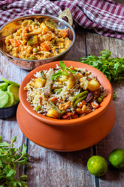 istock Navratan Pulao is a rich, aromatic Indian rice dish made with basmati rice, mixed vegetables, nuts, and dried fruits, offering a delightful sweet-savory flavor. 2209686565