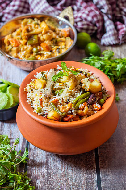 istock Navratan Pulao is a rich, aromatic Indian rice dish made with basmati rice, mixed vegetables, nuts, and dried fruits, offering a delightful sweet-savory flavor. 2209686567