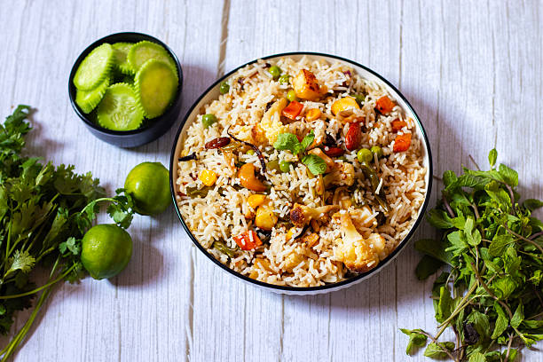 istock Navratan Pulao is a rich, aromatic Indian rice dish made with basmati rice, mixed vegetables, nuts, and dried fruits, offering a delightful sweet-savory flavor. 2209686607