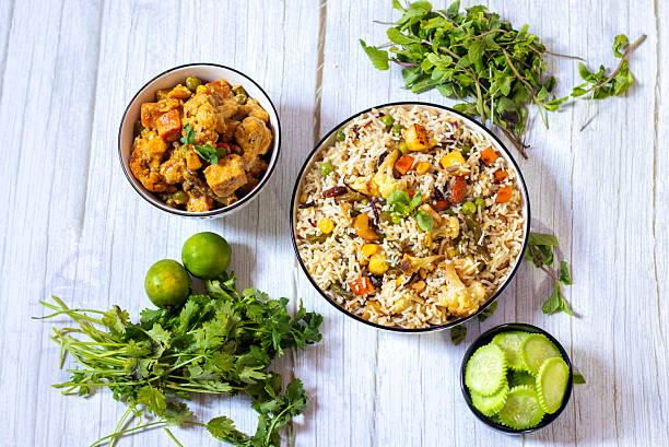 istock Navratan Pulao is a rich, aromatic Indian rice dish made with basmati rice, mixed vegetables, nuts, and dried fruits, offering a delightful sweet-savory flavor. 2209686682